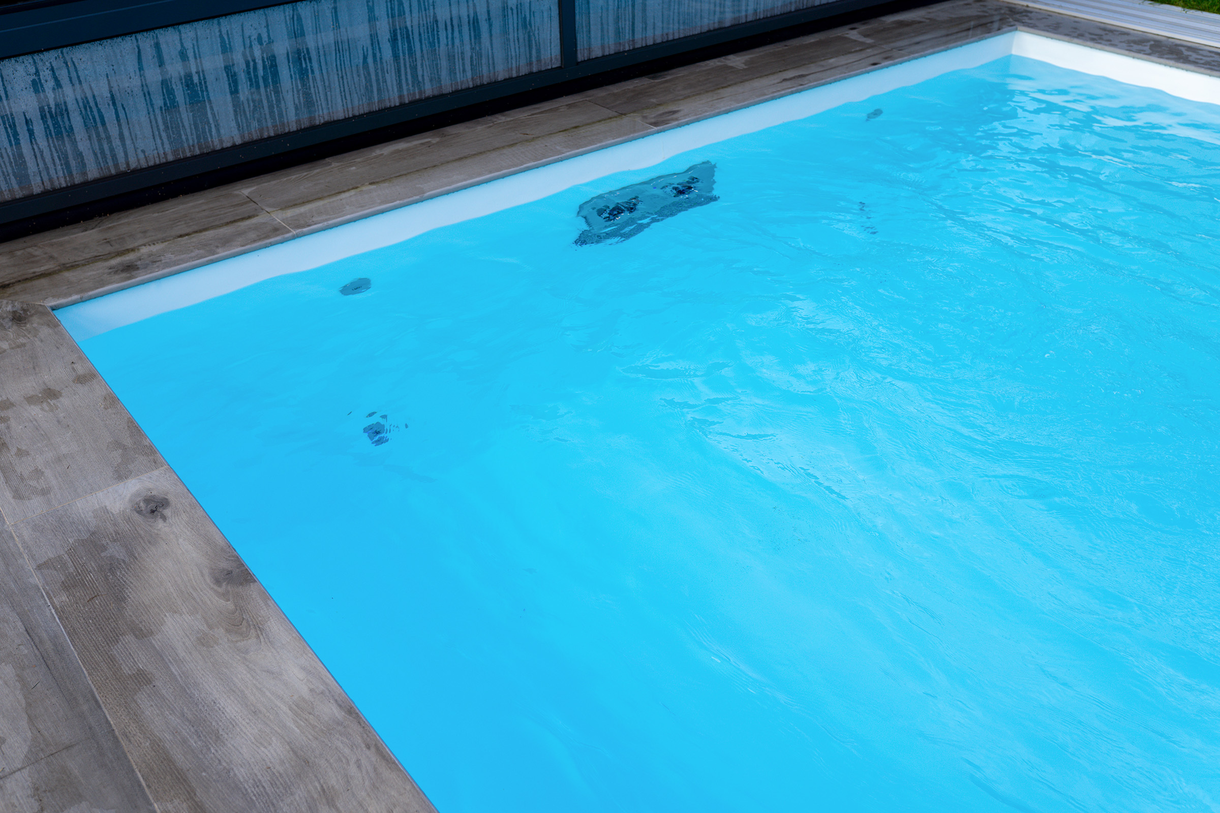 Betonpool mit Luftsprudelsitzbank und Poolüberdachung